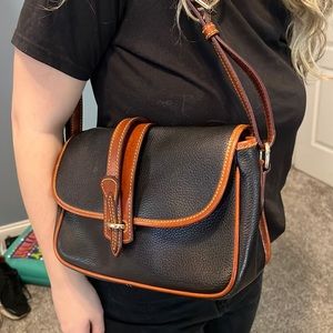 Dooney and Bourke all weather leather. Black and brown. Shoulder bag.
